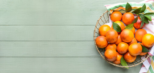 Basket of fresh blood oranges on wooden background with space for text, top view