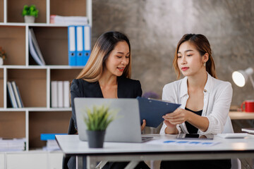 Cropped shot of Asian Business woman diverse coworkers working together in the boardroom, brainstorming, discussing, and analyzing business report strategy collaboration.