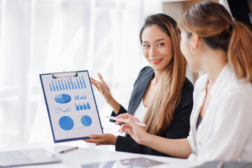 Cropped shot of Asian Business woman diverse coworkers working together in the boardroom, brainstorming, discussing, and analyzing business report strategy collaboration.