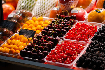 Colorful fruit berries are displayed in a market