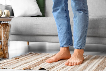 Fototapeta na wymiar Young barefoot man at home, closeup