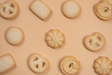 background of cookies on a beige or peach background, food trendy background in pastel colors