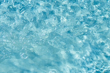 Bright blue water is reflected in the sun. Background