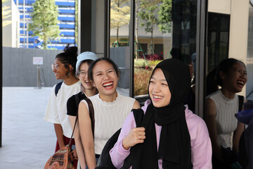 Four young attractive Asian group woman friends colleagues students outdoor building rooftop garden...