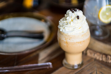 Cold coffee drink frappe (frappuccino), with whipped cream and caramel syrup