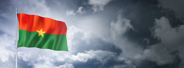 Burkina Faso flag on a cloudy sky