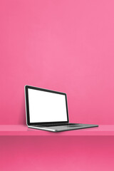 Laptop computer on pink shelf. Vertical background