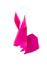 Pink paper rabbit origami isolated on a white background