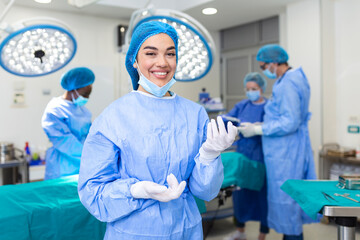 Portrait of female woman nurse surgeon OR staff member dressed in surgical scrubs gown mask and...