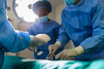 Surgeon team in uniform performs an operation on a patient at a cardiac surgery clinic. Modern medicine, a professional team of surgeons, health.
