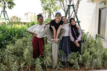 young attractive Asian group woman friends colleagues students garden plants hanging around enjoy...