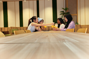 young attractive Asian group woman friends colleagues students indoor dining café restaurant area...