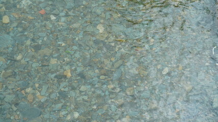 One river view with the clear water and stones laying out on the bottom of the river