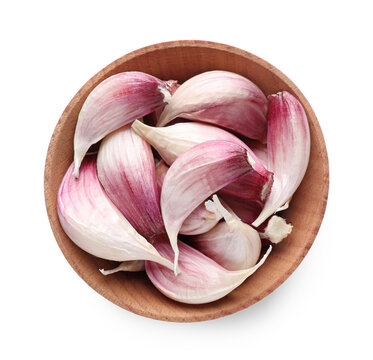 Unpeeled garlic cloves in wooden bowl isolated on white, top view