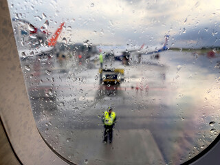 Kaliningrad, Russia, June 19, 2022. service of aircraft in the international airport Khrabrovo. View from the aircraft via wet window during raining