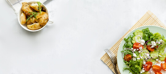Vegetable salad with feta cheese with boiled potatoes for garnish. Greek salad top view. Banner for social networks