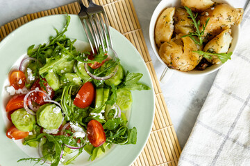 Vegetable salad with feta cheese with boiled potatoes for garnish. Greek salad top view