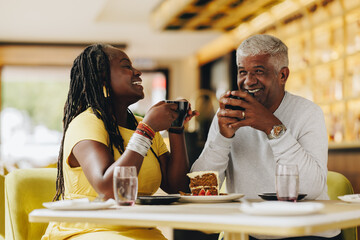 Happy senior couple having coffee together in a cafe