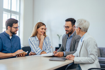 Focused businesspeople working together at the office, ready to sign some contracts.