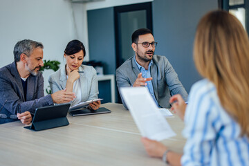 Business people having a meeting in the meeting room, having a conversation.