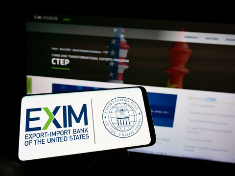 Stuttgart, Germany - 06-19-2022: Person holding mobile phone with logo of Export-Import Bank of the United States (Exim) on screen in front of web page. Focus on phone display.