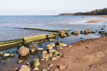 Baltic Sea landscape. Broken concrete pier covered with seaweed