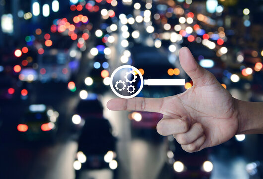 seo flat icon on finger over blur colorful night light traffic jam road in city, Technology search engine optimization concept