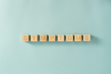 SYMPTOMS word on wooden cubes