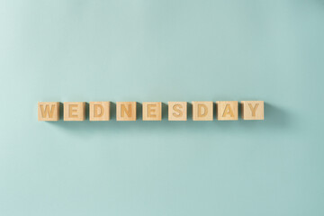 Days of the week written on the wooden cubes on the blue background