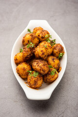 Homemade Roasted Bombay potatoes. Pan fried little baby potatoes or aloo with jeera seeds and coriander in bowl