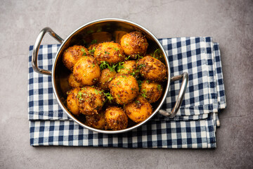 Homemade Roasted Bombay potatoes. Pan fried little baby potatoes or aloo with jeera seeds and coriander in bowl