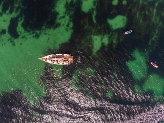 Sailboat on the ocean in the Algarve region in Portugal. Aerial view