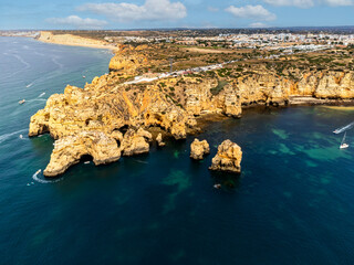 Panoramic view, Ponta da Piedade Lagos in Algarve, Portugal. Cliff rocks,  and tourist boat on sea...