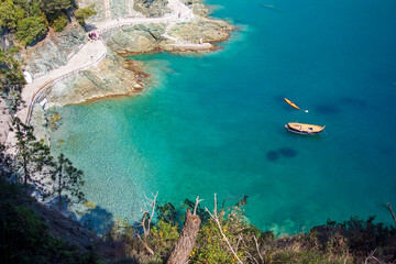 Turquoise blue sea in Liguria. Ligurian sea with boats. Ligurian coast. Aerial view  of the Bonassola seafront promenade, La Spezia, Liguria, Italy.  Panoramic view clear Ligurian sea