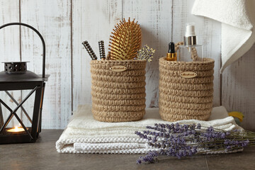 cozy interior in the bathroom with white towels, lavender and hand-knitted jute boxes for accessories and cosmetics, eco-friendly and natural materials, scandinavian style