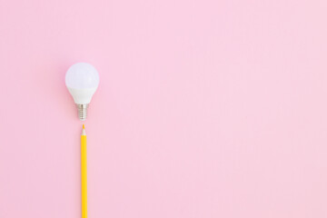 White bulb with yellow pencil on pink background. Idea concept