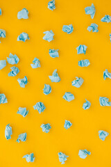 Blue crumpled paper on yellow background. Pattern