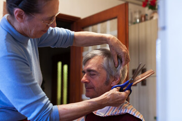 Senior Couple Wife Cutting Her Husband's Hair at Home