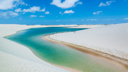 Turquoise water lagoons located in the north east part of Brazil, close to the ocean (Maranhao region, Lencois Maranhenses). White dunes in the foreground. Blue sky in the background.