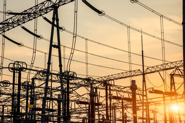 High voltage power tower in substation. Transmission power line. Electricity pylons and sky clouds...