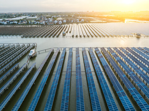 Aerial view of solar power station at beautiful sunset. solar photovoltaic power station on water. green energy concept.