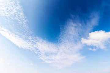 white clouds on a blue sky. nature background in morning light
