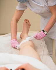 Fragment of laser depilation specialist work close-up on patient's white skin - beauty procedure for smooth skin