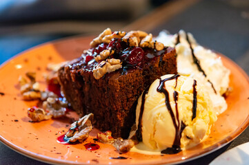 Piece of brownie chocolate cake with vanilla ice cream