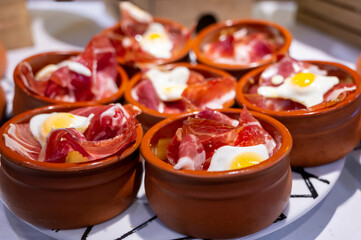 Typical snack of Basque Country and Navarre, pinchos or pinxtos served in bar, San Sebastian, Spain