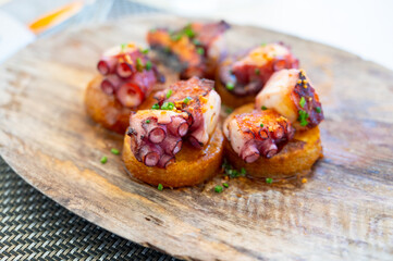 Spanish starter in fish restaurant in Getaria, grilled octopus with roasted potatoes and paprika,...