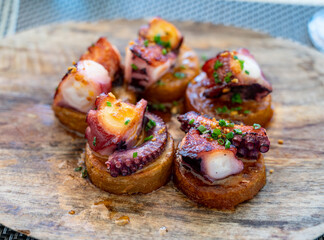 Spanish starter in fish restaurant in Getaria, grilled octopus with roasted potatoes and paprika,...