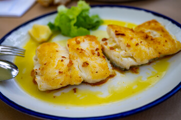 Grilled fillet of white codfish served in fish restaurant in San Sebastian, Basque Country, Spain