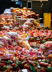 Typical snack of Basque Country and Navarre, pinchos or pinxtos, small piece of bread with different toppings, served in bar, Bilbao, Spain