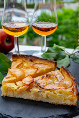 Tasting of baked apple cake and strong alcoholic drink calvados made from apples in Normandy, Calvados region, France